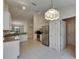 Spacious kitchen with stainless steel appliances, granite countertops, tiled floors, and ample cabinet space for storage at 1003 Clearpointe Way, Lakeland, FL 33813