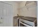 Well-equipped laundry room with modern washer and dryer, complemented by shelving for organized storage solutions at 1003 Clearpointe Way, Lakeland, FL 33813