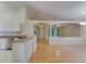 Open-concept living room with hardwood floors, and an open kitchen with granite countertops at 1003 Clearpointe Way, Lakeland, FL 33813