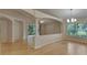 Open living room featuring hardwood floors, decorative columns, and natural light at 1003 Clearpointe Way, Lakeland, FL 33813