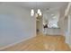 Living room features an open layout, hardwood floors, and elegant chandelier at 1003 Clearpointe Way, Lakeland, FL 33813