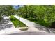 Well-manicured street view featuring landscaped sidewalks and mature trees providing shade at 1003 Clearpointe Way, Lakeland, FL 33813