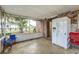 Enclosed porch with full-sized refrigerator; great space for relaxing and outdoor entertaining at 102 Pike St, Auburndale, FL 33823