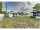The backyard features a storage shed, a lush lawn, and partial fencing for privacy at 102 Pike St, Auburndale, FL 33823