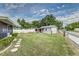 Well-maintained backyard with green grass, a shed, and a secure fence at 102 Pike St, Auburndale, FL 33823