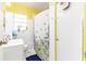 Bright bathroom with a floral shower curtain and a sink at 102 Pike St, Auburndale, FL 33823