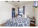 Cozy bedroom with a plush bed, wood-look floors and ample natural light at 102 Pike St, Auburndale, FL 33823