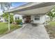 Charming home exterior with a covered parking area and well maintained landscaping at 102 Pike St, Auburndale, FL 33823