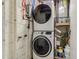 Laundry room with modern stacked washer and dryer units at 102 Pike St, Auburndale, FL 33823