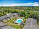 Elevated view of apartment buildings featuring a pool, surrounded by lush greenery and mature trees, creating a serene setting at 110 N Tremain St # 206, Mount Dora, FL 32757