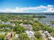 Expansive aerial view showcasing a community nestled near a tranquil lake, surrounded by lush trees and beautiful homes at 110 N Tremain St # 206, Mount Dora, FL 32757