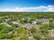 Expansive aerial view of property with lush surrounding greenery, multiple buildings, and a swimming pool on a sunny day at 110 N Tremain St # 206, Mount Dora, FL 32757