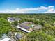 Stunning aerial view of an apartment complex surrounded by lush greenery, showcasing a community pool and ample parking at 110 N Tremain St # 206, Mount Dora, FL 32757