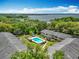 Stunning aerial view showcasing apartments surrounding a sparkling pool, offering scenic views of the nearby lake at 110 N Tremain St # 206, Mount Dora, FL 32757