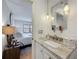 Elegant bathroom vanity area with granite countertop and decorative mirror at 110 N Tremain St # 206, Mount Dora, FL 32757