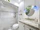 Bathroom with glass-enclosed shower, modern vanity with sink, and a decorative light fixture at 110 N Tremain St # 206, Mount Dora, FL 32757
