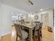 Dining room with wood floors, modern pendant lights, and a glimpse into the adjacent kitchen at 110 N Tremain St # 206, Mount Dora, FL 32757
