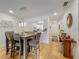 Open-concept dining room with wood floors, modern lighting, and views into the kitchen at 110 N Tremain St # 206, Mount Dora, FL 32757