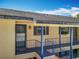 Condo featuring a private porch with blue railings, offering a welcoming entrance to the home at 110 N Tremain St # 206, Mount Dora, FL 32757