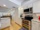 Modern kitchen with stainless steel appliances and breakfast bar open to the dining area at 110 N Tremain St # 206, Mount Dora, FL 32757