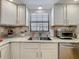 Well-lit kitchen with stainless steel appliances, granite countertops, and ample cabinet space at 110 N Tremain St # 206, Mount Dora, FL 32757