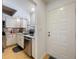 Bright kitchen with white cabinets, stainless steel appliances, and hardwood floors at 110 N Tremain St # 206, Mount Dora, FL 32757