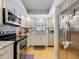 Modern kitchen with stainless steel appliances, granite countertops, and a bright window at 110 N Tremain St # 206, Mount Dora, FL 32757