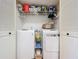 Conveniently organized laundry room with washer, dryer, storage shelves, and plenty of space at 110 N Tremain St # 206, Mount Dora, FL 32757