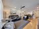 Open-concept living area featuring comfortable seating, and a view of the kitchen and dining area at 110 N Tremain St # 206, Mount Dora, FL 32757