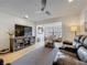 Inviting living room featuring comfortable seating, a ceiling fan, and a stylish entertainment center at 110 N Tremain St # 206, Mount Dora, FL 32757
