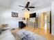Inviting living room with television, shelving, comfortable couch and a ceiling fan at 110 N Tremain St # 206, Mount Dora, FL 32757