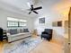 Cozy living room featuring a comfortable couch, chair, and large area rug at 110 N Tremain St # 206, Mount Dora, FL 32757