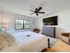 Relaxing main bedroom featuring a ceiling fan, a large bed, and an outside view at 110 N Tremain St # 206, Mount Dora, FL 32757