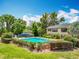 Sparkling pool surrounded by well-manicured hedges and lush landscaping, creating a private oasis at 110 N Tremain St # 206, Mount Dora, FL 32757