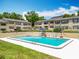 Inviting swimming pool offering a refreshing escape, complete with comfortable lounge chairs and umbrellas at 110 N Tremain St # 206, Mount Dora, FL 32757