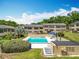 Relaxing pool area with lounge chairs and umbrellas, perfect for enjoying the outdoors at 110 N Tremain St # 206, Mount Dora, FL 32757