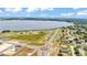 An aerial view shows waterfront community homes near a large, beautiful lake on a clear day at 1146 Enclave Ct., Auburndale, FL 33823