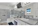 Bright bathroom featuring double sinks with marble countertops, a window, and a glass enclosed shower at 1146 Enclave Ct., Auburndale, FL 33823