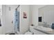 Bathroom with a shower/tub with a blue and white curtain, a sink with a grey countertop, and white walls at 1146 Enclave Ct., Auburndale, FL 33823