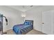 Bedroom with a full sized bed with blue bedding, a weight machine, and a floor lamp at 1146 Enclave Ct., Auburndale, FL 33823