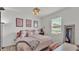 Cozy bedroom featuring a full sized bed with pink bedding, art, and a window with a blind at 1146 Enclave Ct., Auburndale, FL 33823