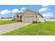 This single-Gathering home features a spacious two-car garage and a lush green lawn at 1146 Enclave Ct., Auburndale, FL 33823