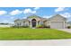 Charming single-story home with a well-manicured lawn and inviting entrance at 1146 Enclave Ct., Auburndale, FL 33823