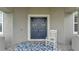 Inviting front door with double doors, rocking chair, and stylish outdoor rug at 1146 Enclave Ct., Auburndale, FL 33823