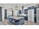 Stylish kitchen with stainless steel appliances, large island, and modern pendant lighting at 1146 Enclave Ct., Auburndale, FL 33823