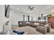 Spacious living room featuring a large sectional sofa and open floor plan with modern decor at 1146 Enclave Ct., Auburndale, FL 33823