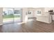 Open-concept living room and kitchen with sliding glass doors leading to the backyard at 1420 Portmore Dr, Mulberry, FL 33860