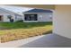 Exterior shot from the covered lanai looking out over the lawn towards another home at 1420 Portmore Dr, Mulberry, FL 33860