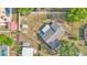 Overhead shot of a home with a patio, storage sheds, mature trees in the backyard, and fully fenced yard at 1423 Ridgegreen N Loop, Lakeland, FL 33809
