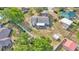 Overhead shot of a home with a fully fenced backyard, patio area, storage sheds and mature trees in a residential area at 1423 Ridgegreen N Loop, Lakeland, FL 33809